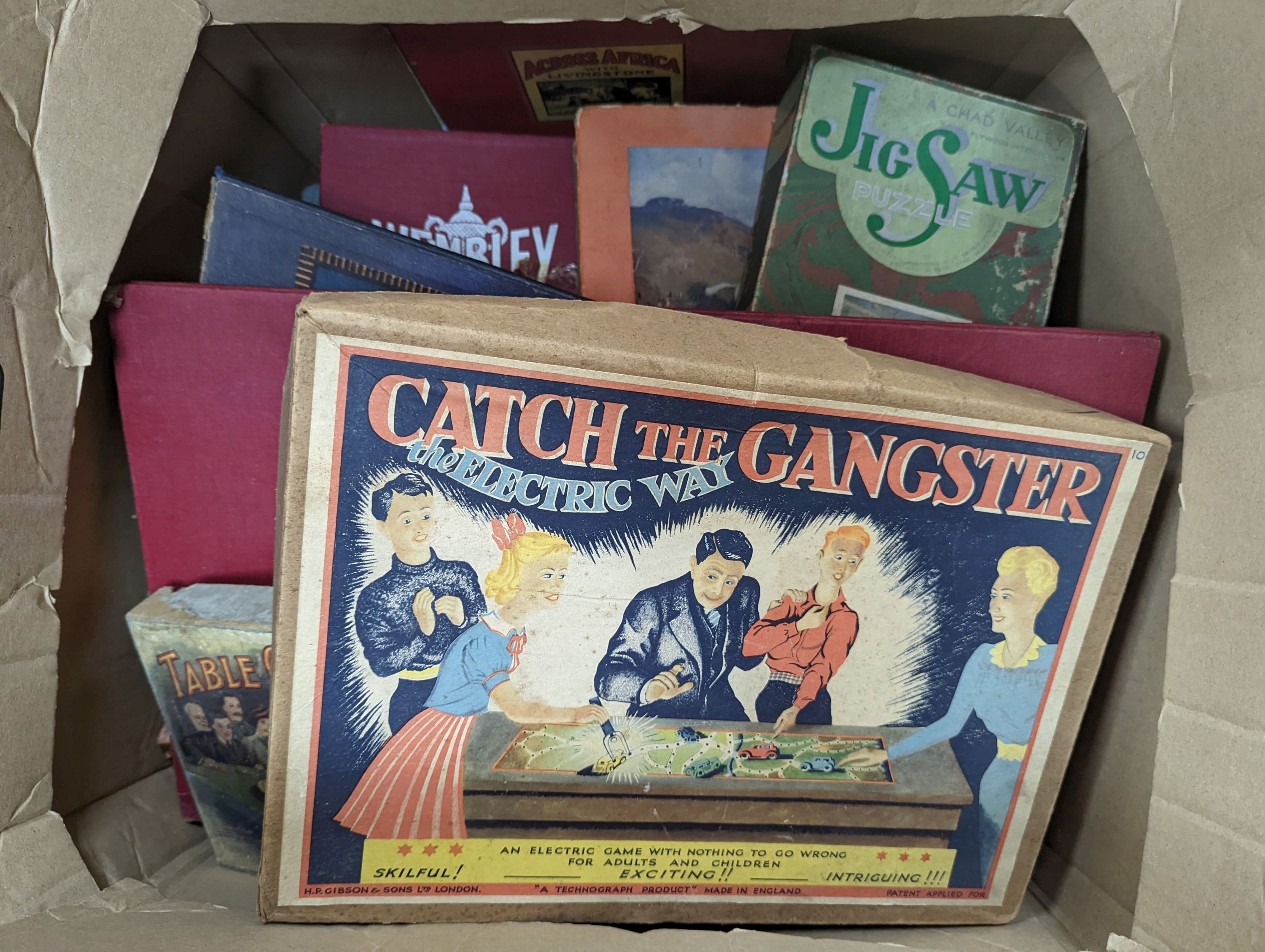 Two boxes containing games and puzzles, late 19th to mid 20th century